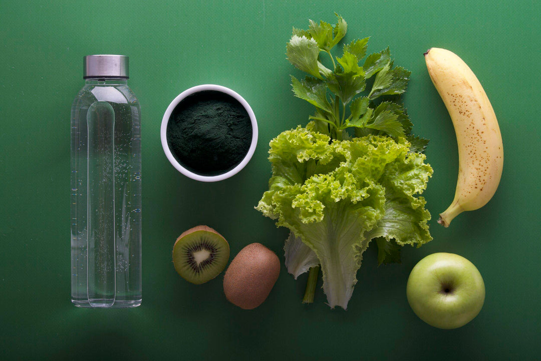 A photo of different foods on a green surface that will benefit acneic skin